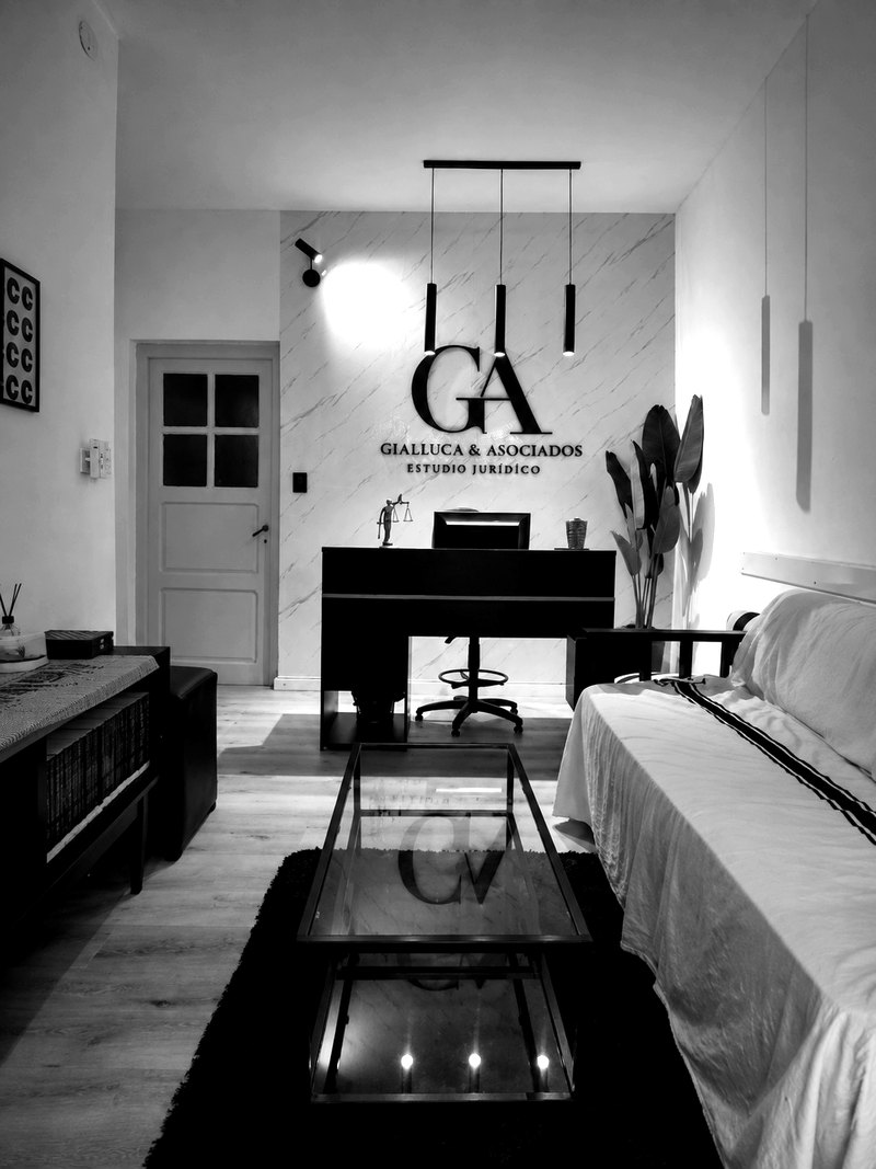 Sala de recepción del estudio con el logo GA sobre la pared de mármol